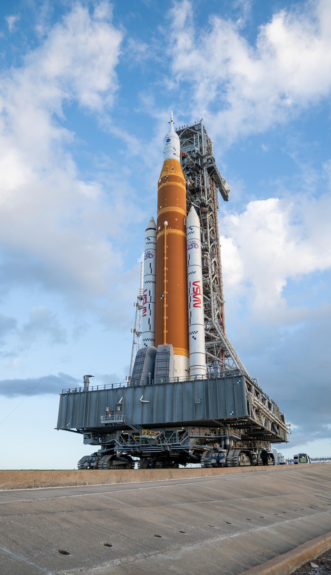 This image shows NASA’s SLS (Space Launch System) and Orion spacecraft rolling out of the Vehicle Assembly Building at NASA’s Kennedy Space Center. NASA's massive Crawler-Transporter, upgraded for the Artemis program, carries the powerful SLS rocket and Orion spacecraft on the Mobile Launcher from the Vehicle Assembly Building to Launch Pad 39B at Kennedy Space Center in preparation for the Artemis II mission. 